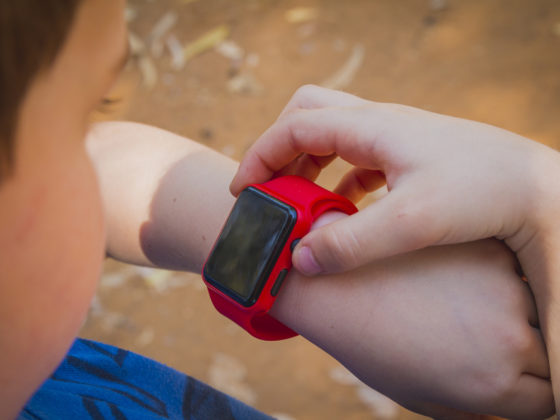 Young boy looking at Smart Watch