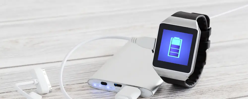 Smart watch charging with energy bank. Smartwatch concept.