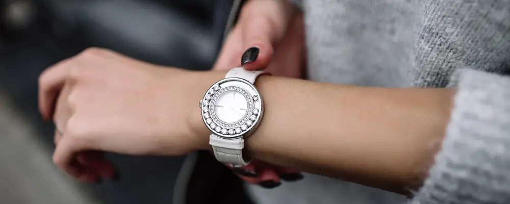 white women's wrist watch on the girl's hand
