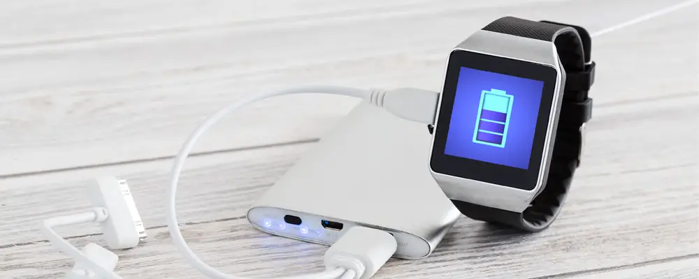 Smart watch charging with energy bank. Smartwatch concept.